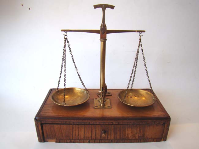 A lovely set of antique jeweler's scales mounted on a fruitwood base circa 1860